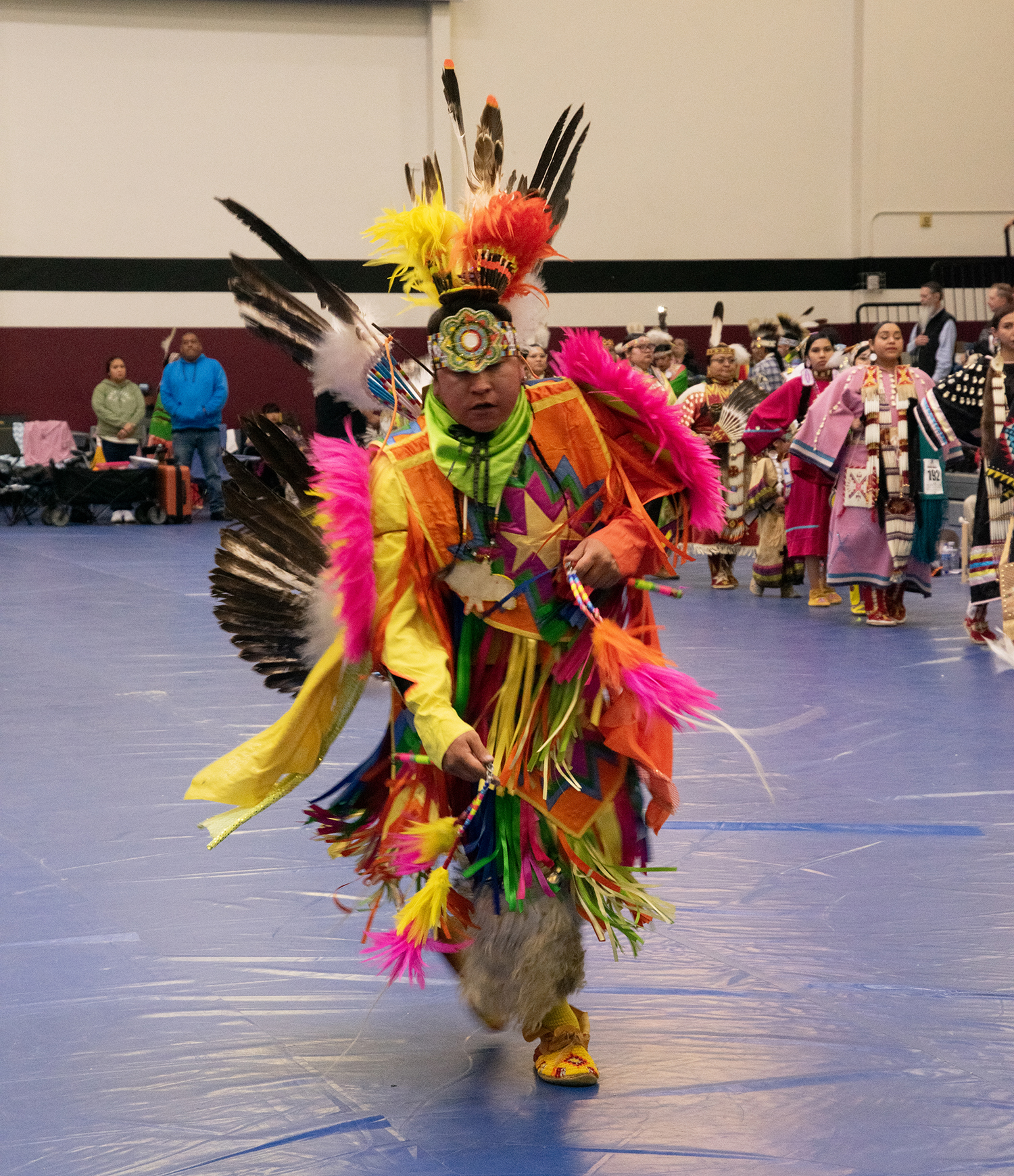 Dancer in traditional colorful regalia at Grand Mesa Pow-Wow