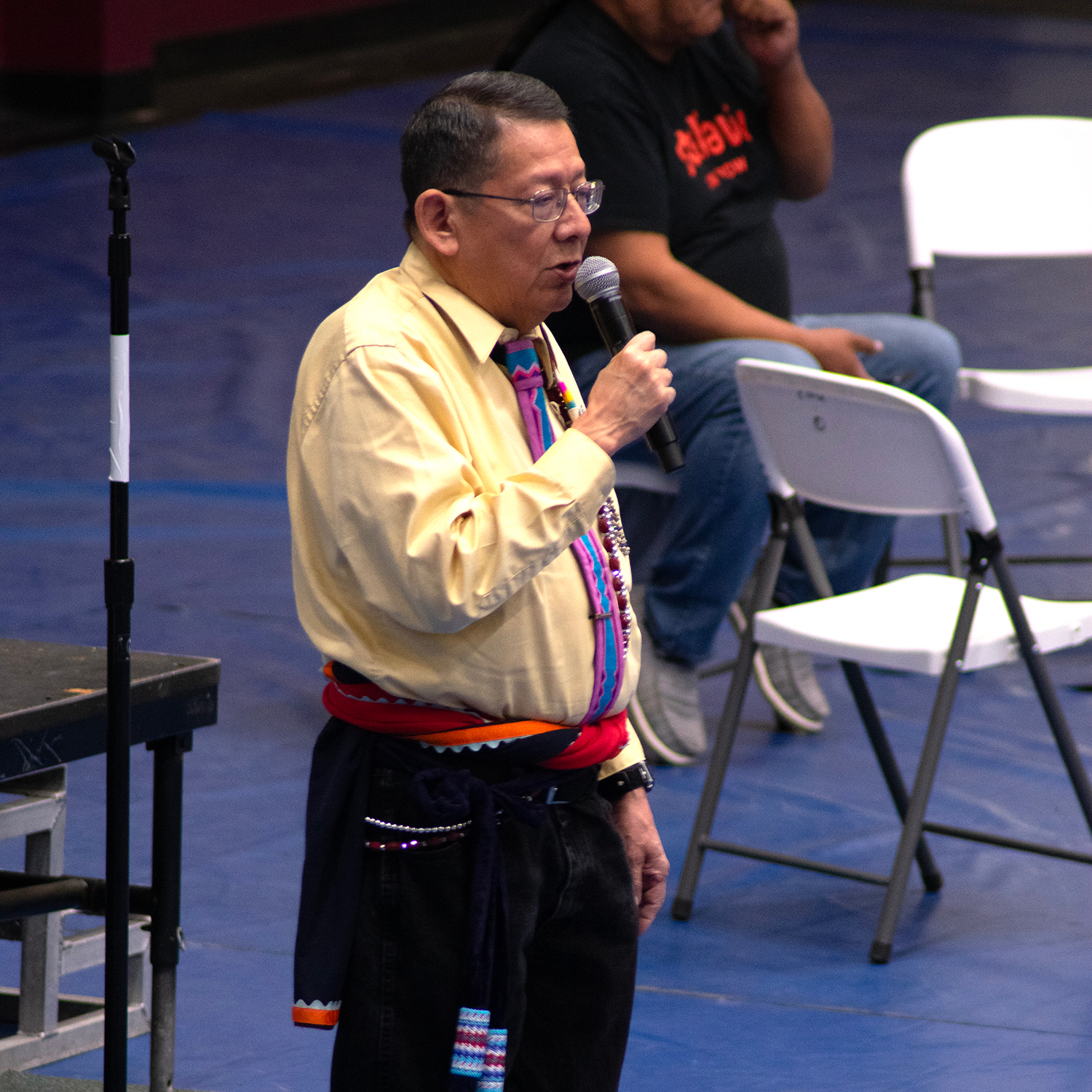Man speaking into a microphone at a Pow-Wow