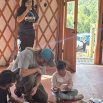 Adult and child in a yurt activity