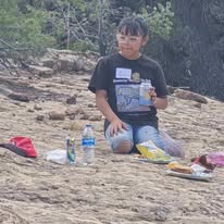 Young person having a picnic on rocky ground