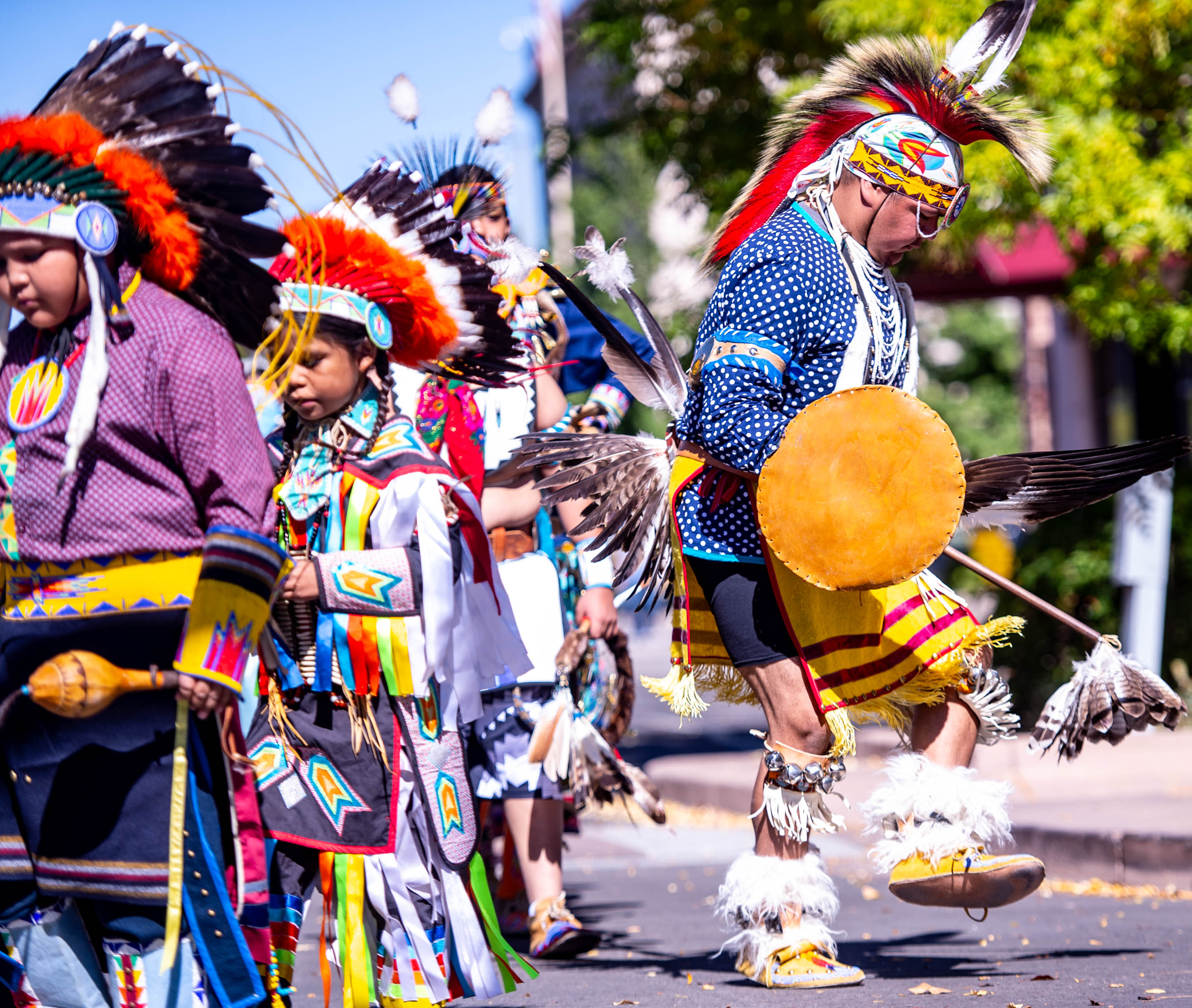 Native American dancers in traditional regalia performing