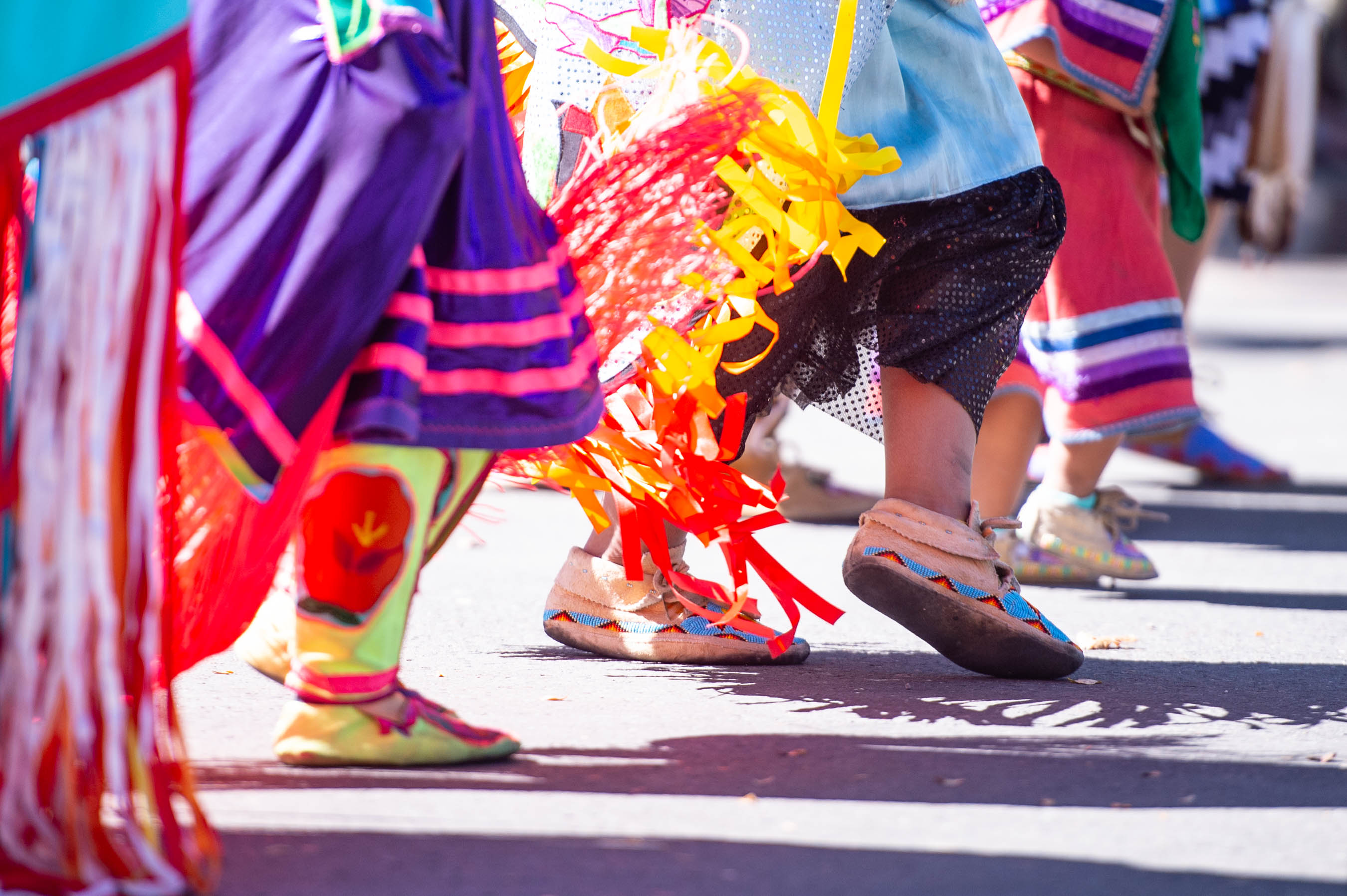 Native American dancers in traditional regalia performing outdoors
