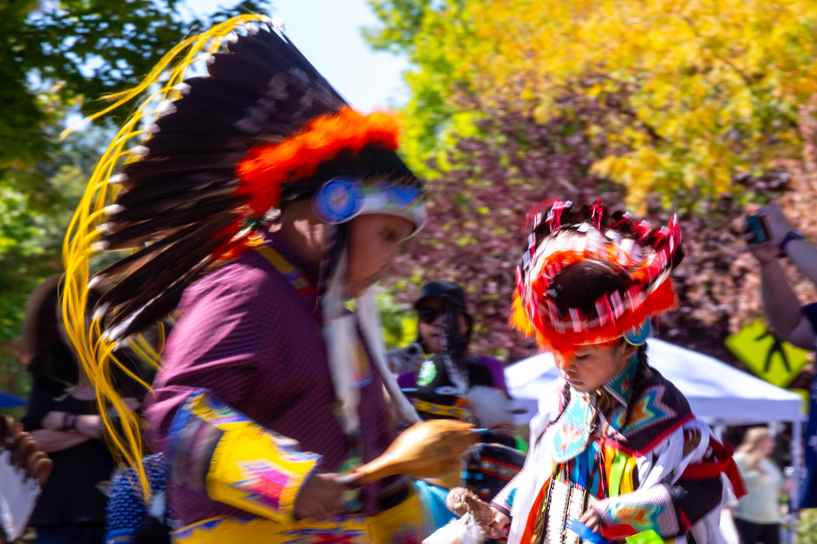 Native American dancers in traditional regalia outdoors
