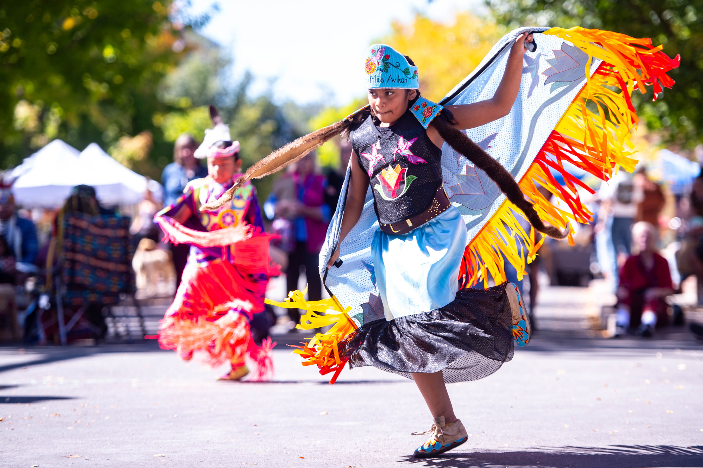 Young Native American dancer in traditional regalia performing