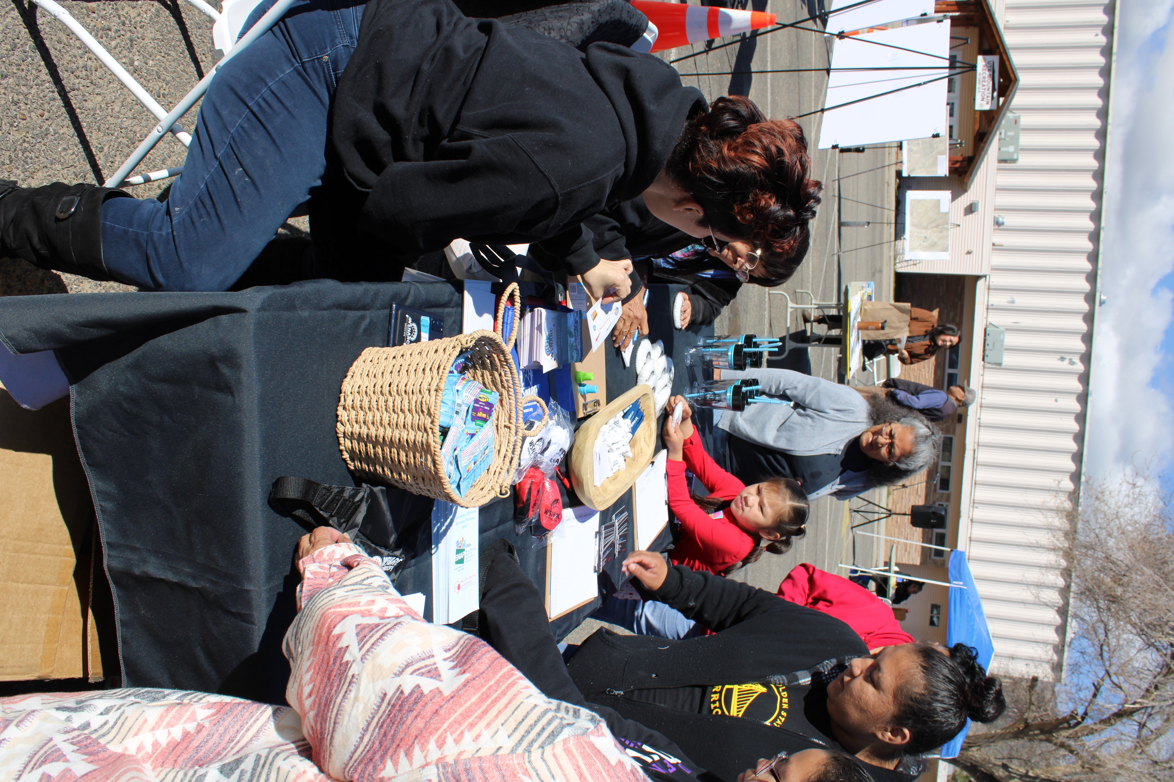 People interacting at a community event table
