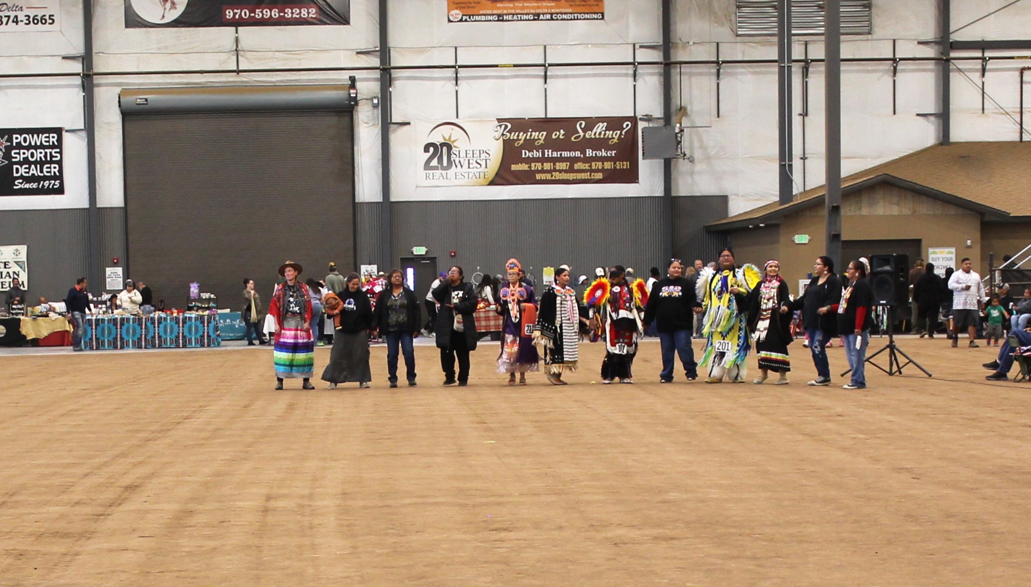 Participants in traditional regalia at pow-wow