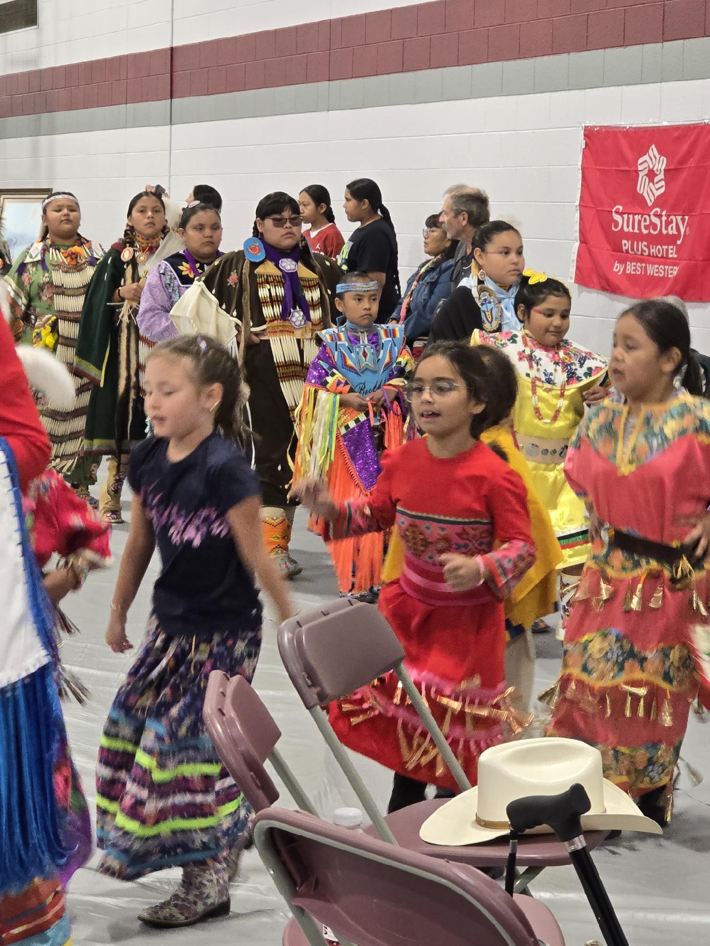 Children in traditional regalia dancing