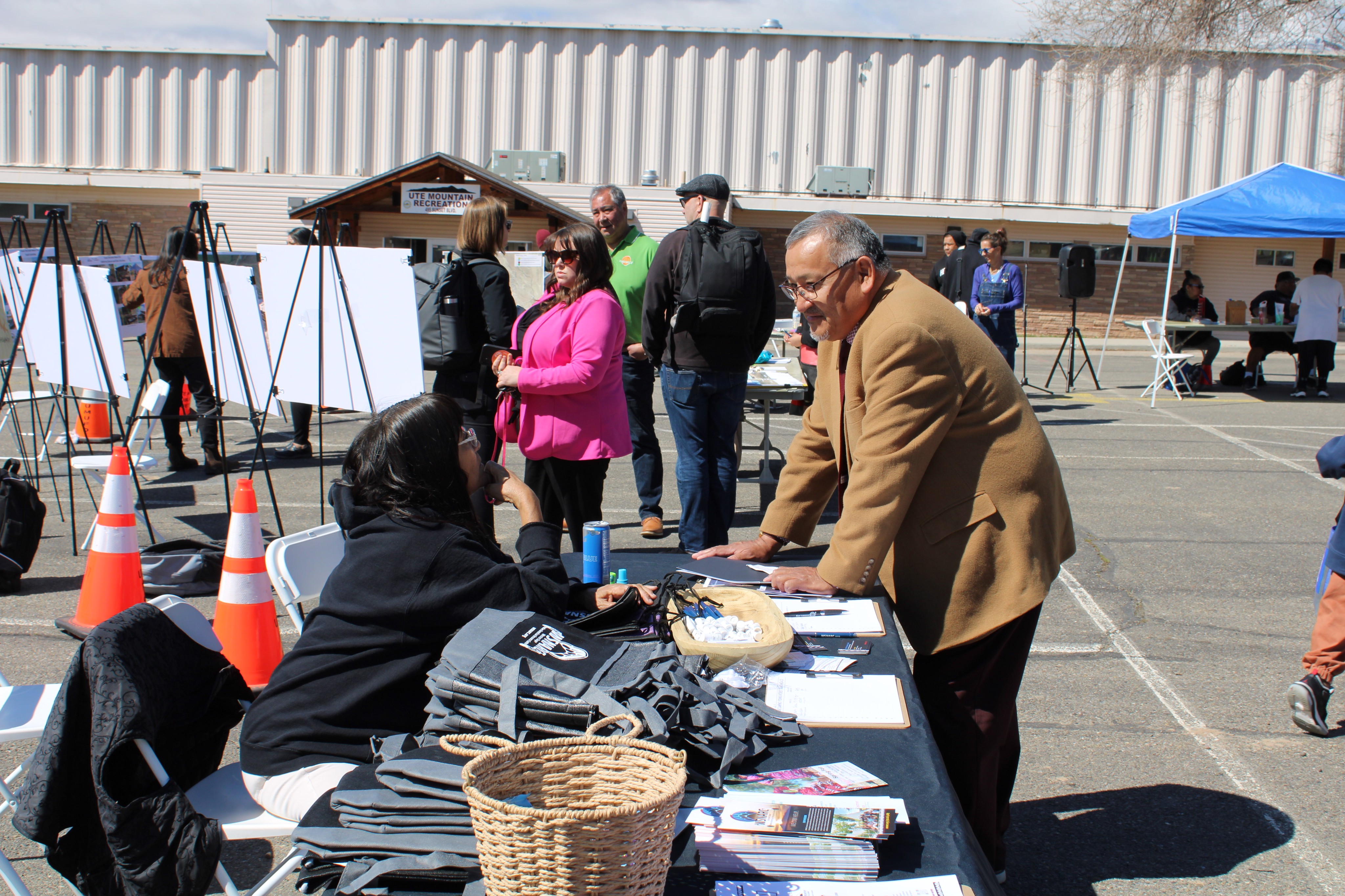 People at outdoor community information booth