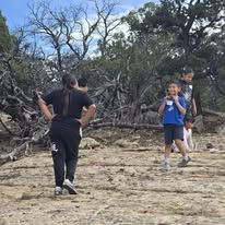 Children hiking on a rocky trail outdoors